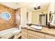 Updated bathroom with a large vanity, a shower/tub combo, and a stylish stone accent at 8638 E Paraiso Dr, Scottsdale, AZ 85255