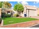 Tan home with a two-car garage and well-maintained lawn at 8638 E Paraiso Dr, Scottsdale, AZ 85255