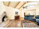 Living room with a fireplace, teal sofa and high ceilings at 8638 E Paraiso Dr, Scottsdale, AZ 85255