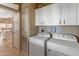 Bright laundry room, featuring washer, dryer, and ample cabinet storage at 11596 W Sierra Dawn Blvd # 377, Surprise, AZ 85378