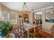 Spacious dining area with a chandelier and a view into the living room at 11596 W Sierra Dawn Blvd # 377, Surprise, AZ 85378