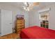 Bedroom with red bedding and wooden dresser at 11596 W Sierra Dawn Blvd # 377, Surprise, AZ 85378