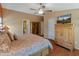 Main bedroom with king bed, wood furniture, and access to the bathroom at 11596 W Sierra Dawn Blvd # 377, Surprise, AZ 85378
