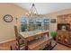Dining area features a rustic wooden table and bench, a chandelier and hutch at 11596 W Sierra Dawn Blvd # 377, Surprise, AZ 85378