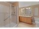 Bathroom with double sinks, shower, and wood cabinets at 11596 W Sierra Dawn Blvd # 377, Surprise, AZ 85378