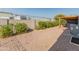 Small backyard with gravel, shrubs, and AC unit at 11596 W Sierra Dawn Blvd # 377, Surprise, AZ 85378