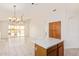 Kitchen with island, wood cabinets and views to backyard at 11532 W Piccadilly Rd, Avondale, AZ 85392