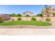Landscaped backyard with a curved lawn and block wall at 4882 E Amarillo Dr, San Tan Valley, AZ 85140