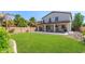 Large backyard with grassy area, covered patio, and rock landscaping at 4882 E Amarillo Dr, San Tan Valley, AZ 85140