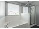 Clean bathroom with a soaking tub, a large shower, and a window at 4882 E Amarillo Dr, San Tan Valley, AZ 85140