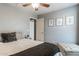 Cozy bedroom with a queen bed, ottoman, and access to another room at 4882 E Amarillo Dr, San Tan Valley, AZ 85140