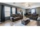 Spacious living room with two brown sofas, coffee table, and large windows at 4882 E Amarillo Dr, San Tan Valley, AZ 85140