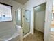 Bathroom with shower, tub, and access to a walk-in closet at 36085 W Catalan St, Maricopa, AZ 85138