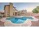 Inviting kidney-shaped pool with tan tile deck at 4944 W Oraibi Dr, Glendale, AZ 85308