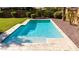 Clean rectangular pool with light-colored stone decking at 18658 N Tanners Way, Maricopa, AZ 85138