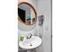 Powder room with pedestal sink and oval mirror at 39115 N 99Th Pl, Scottsdale, AZ 85262