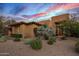 Stunning stucco home with desert landscaping at sunset at 39115 N 99Th Pl, Scottsdale, AZ 85262