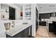 Modern kitchen with dark cabinets and a large island at 39115 N 99Th Pl, Scottsdale, AZ 85262