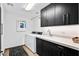 Bright laundry room, featuring modern cabinetry, and a utility sink at 39115 N 99Th Pl, Scottsdale, AZ 85262