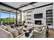 Modern living room with a fireplace and stunning views at 39115 N 99Th Pl, Scottsdale, AZ 85262