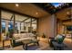 Evening view of a relaxing patio with comfortable seating and a view into the home's interior at 39115 N 99Th Pl, Scottsdale, AZ 85262