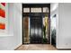 Elegant entryway with a black door and wood floors at 39115 N 99Th Pl, Scottsdale, AZ 85262