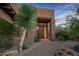 Front entry with mature plants and a stone walkway at 39115 N 99Th Pl, Scottsdale, AZ 85262