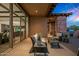 Relaxing outdoor patio with seating area, offering views of the kitchen and surrounding landscape at 39115 N 99Th Pl, Scottsdale, AZ 85262