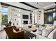 Bright living room with a fireplace and built-in shelving at 39115 N 99Th Pl, Scottsdale, AZ 85262