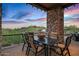 Patio dining area with seating for six and scenic views at 39115 N 99Th Pl, Scottsdale, AZ 85262