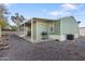 Side view of a green manufactured home with a covered patio and gravel landscaping at 8600 E Broadway Rd # 147, Mesa, AZ 85208