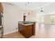 Kitchen with a breakfast bar, wood cabinets, granite countertops, and tile flooring at 18112 W Spencer Dr, Surprise, AZ 85374