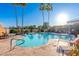 Relaxing community pool with lounge chairs and palm trees at 18112 W Spencer Dr, Surprise, AZ 85374