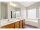 Bathroom with double vanity, bathtub and shower at 18112 W Spencer Dr, Surprise, AZ 85374