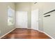 Bedroom with wood flooring, sliding doors and window at 18112 W Spencer Dr, Surprise, AZ 85374