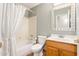 Clean bathroom with tub shower, toilet and wood vanity at 18112 W Spencer Dr, Surprise, AZ 85374