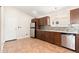Modern kitchen with wood cabinets, granite countertops, and stainless steel appliances at 18112 W Spencer Dr, Surprise, AZ 85374