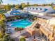 Community pool with adjacent clubhouse and seating at 18112 W Spencer Dr, Surprise, AZ 85374
