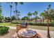 Community BBQ area with a table and seating, overlooking the pool and grounds at 10030 W Indian School Rd # 221, Phoenix, AZ 85037