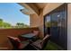 Private patio with small table and chairs, ideal for relaxing at 10030 W Indian School Rd # 221, Phoenix, AZ 85037