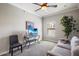 Bright living room with gray sofa, ceiling fan, and flat-screen TV at 21320 N 56Th St # 2145, Phoenix, AZ 85054