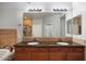 Double vanity bathroom with granite countertops and large mirror at 21320 N 56Th St # 2145, Phoenix, AZ 85054