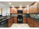 Modern kitchen with granite countertops, dark wood cabinets, and stainless steel appliances at 21320 N 56Th St # 2145, Phoenix, AZ 85054