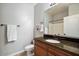 Bathroom with granite countertops, wood cabinets, and a large mirror at 21320 N 56Th St # 2145, Phoenix, AZ 85054