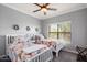 Cozy bedroom with twin beds, ceiling fan and bright window at 21320 N 56Th St # 2145, Phoenix, AZ 85054