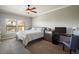 Spacious bedroom with a king-size bed, a desk and chair, and ceiling fan at 21320 N 56Th St # 2145, Phoenix, AZ 85054