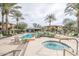 Community pool and spa with lounge chairs and palm trees at 21320 N 56Th St # 2145, Phoenix, AZ 85054