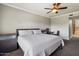 King-size bed, dresser, and desk in this bright bedroom with ceiling fan at 21320 N 56Th St # 2145, Phoenix, AZ 85054