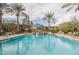 Community pool with lounge chairs and a water feature at 21320 N 56Th St # 2145, Phoenix, AZ 85054