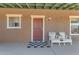 Charming front entrance with a red door and two white adirondack chairs at 29315 N 140Th St, Scottsdale, AZ 85262